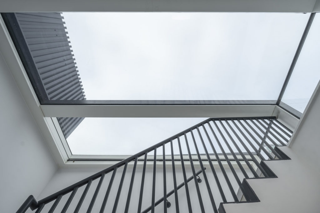 Internal stairwell illuminated by a bespoke three-wall box rooflight at 14 St John’s Lane Clerkenwell Project.