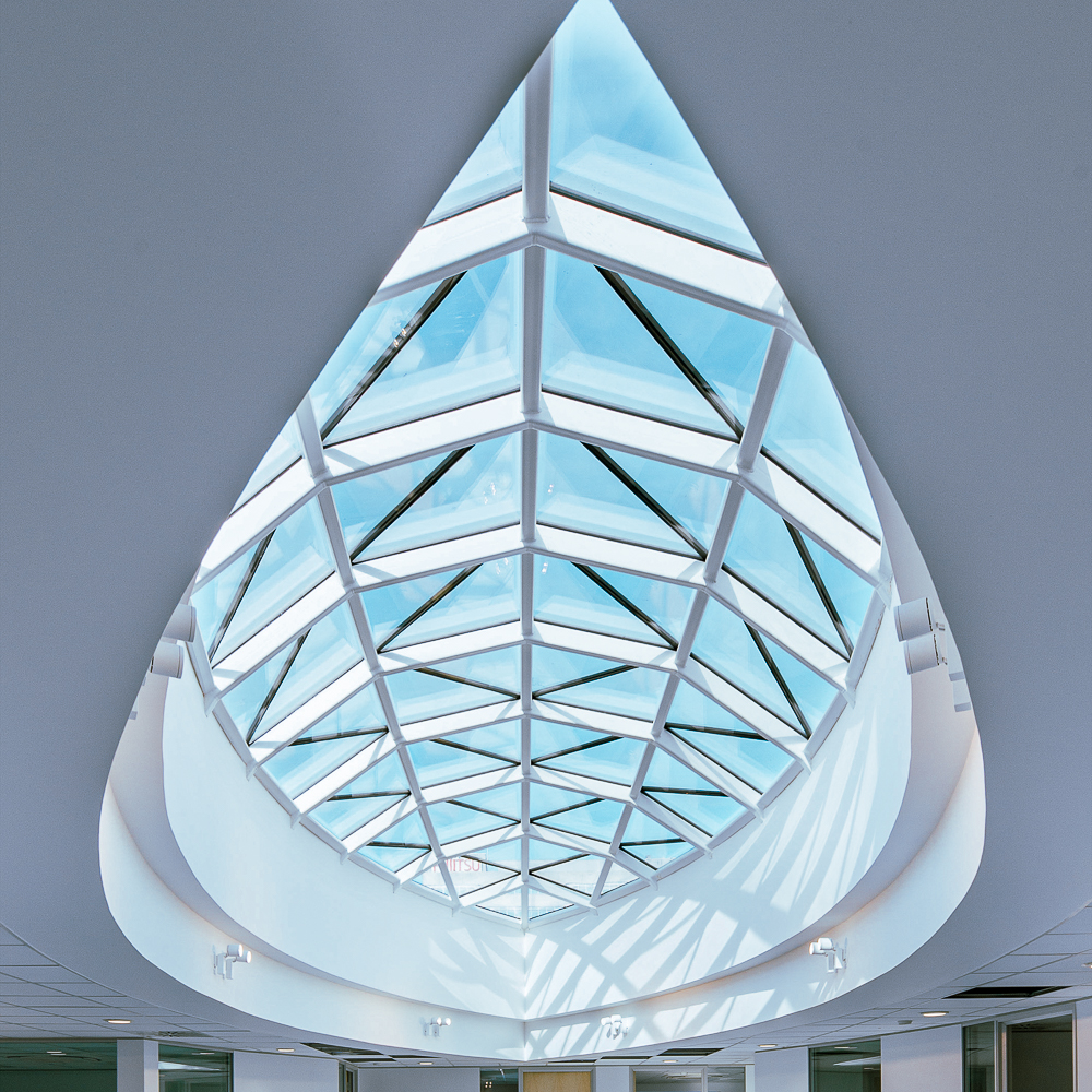 A triangular glass ceiling with a geometric grid pattern, allowing natural light into the room below.