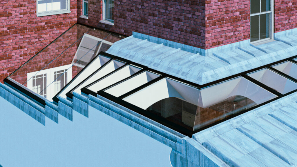 A modern building with red brick walls features a series of glass skylights integrated into a blue metal roof structure.