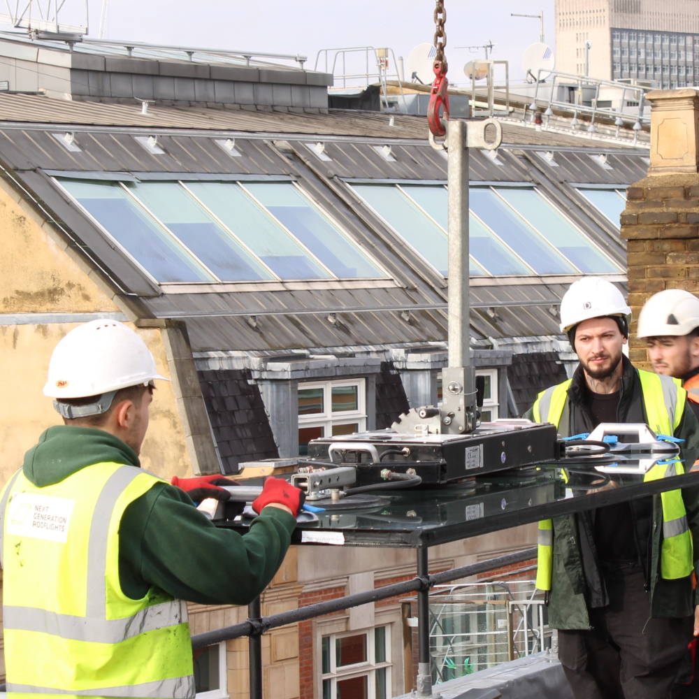 A rooftop with a large open skylight overlooking a cityscape, featuring surrounding buildings and a partly cloudy sky.