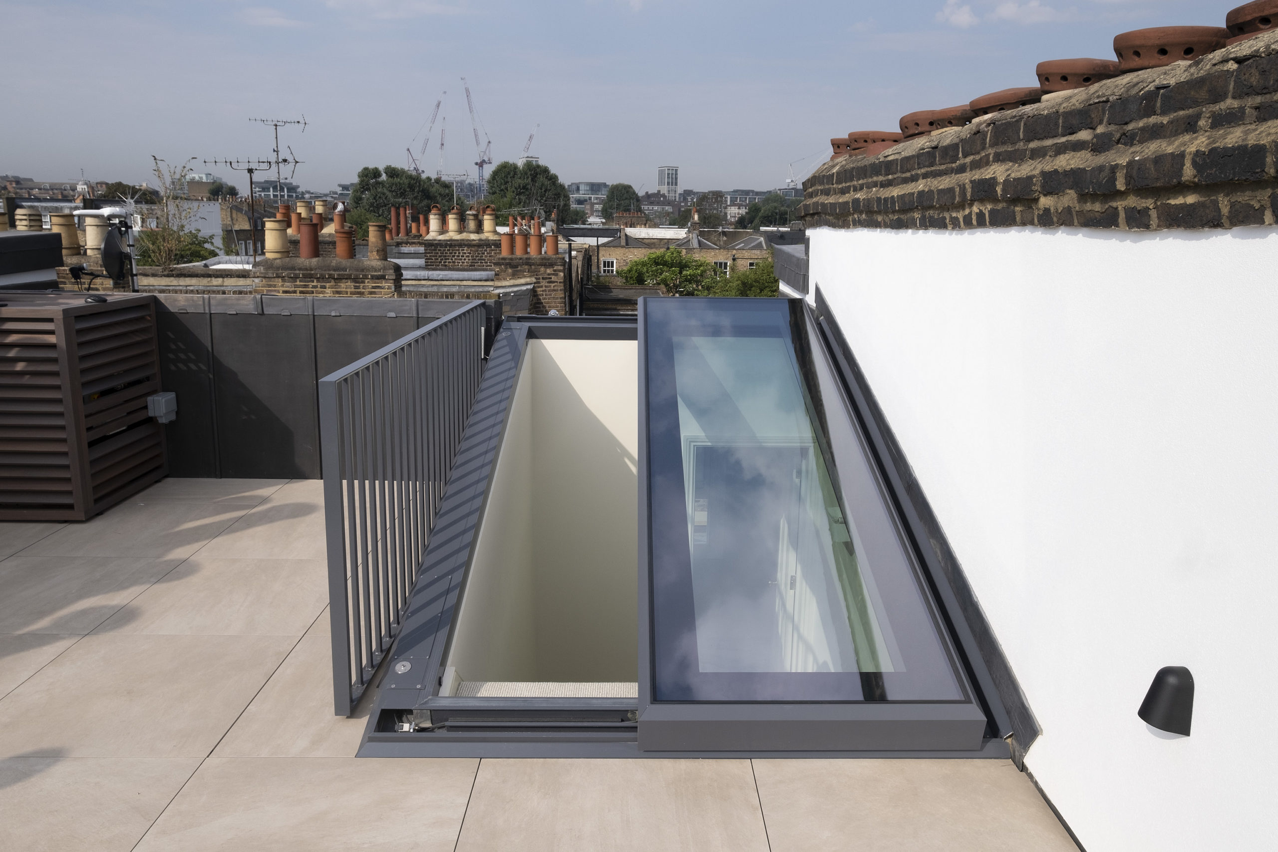 slide-over-fixed-sliding-rooflight-roof-terrace-access-abingdon-road Slide over fixed sliding rooflight with 50% opening providing access to roof terrace access on flat roof residential property in Abingdon Road.