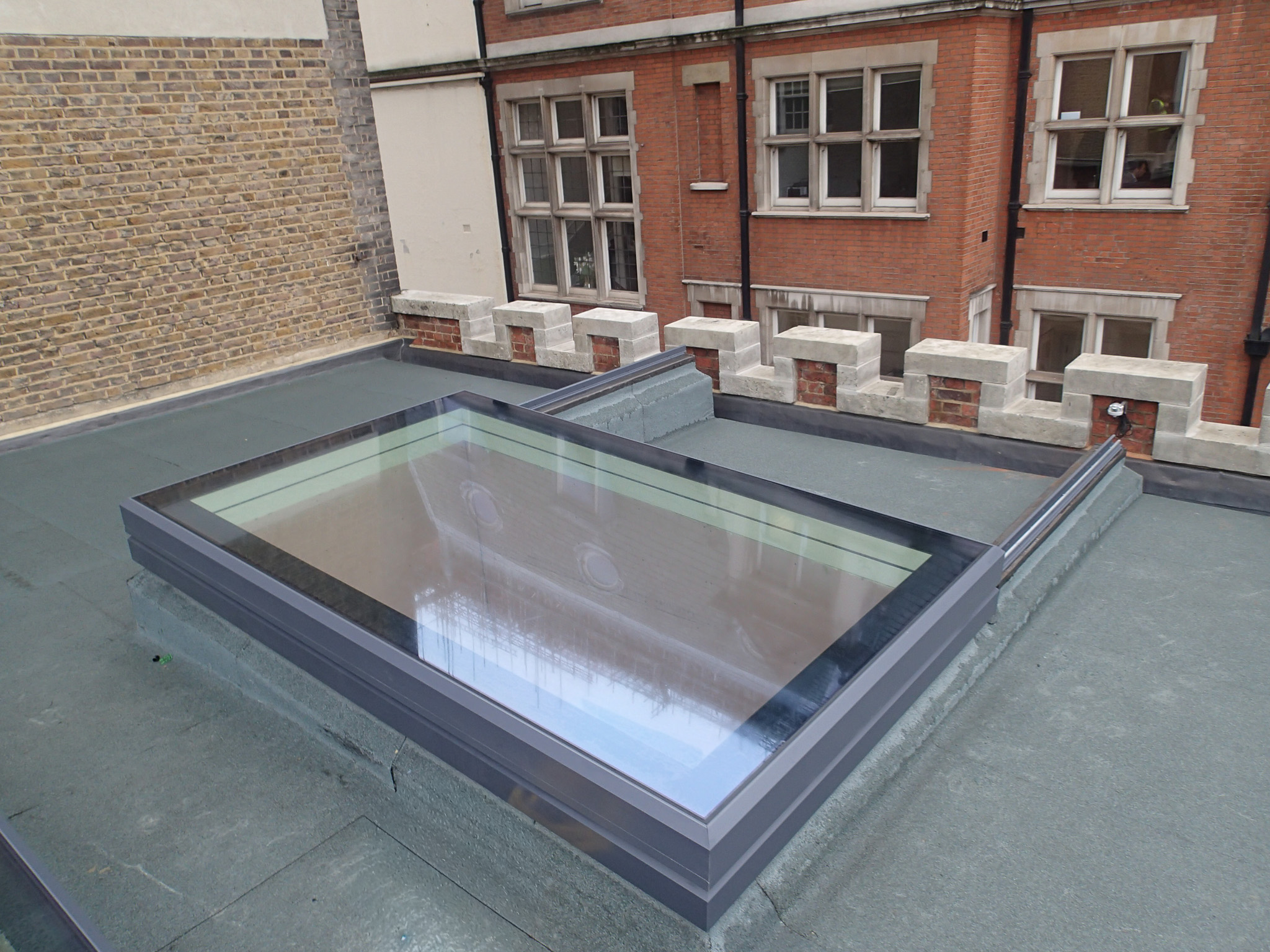 Slide Over Roof Sliding Rooflight – 100% Opening for Roof Terrace Access Slide over roof sliding rooflight providing 100% opening for regular roof terrace access on flat roof property.