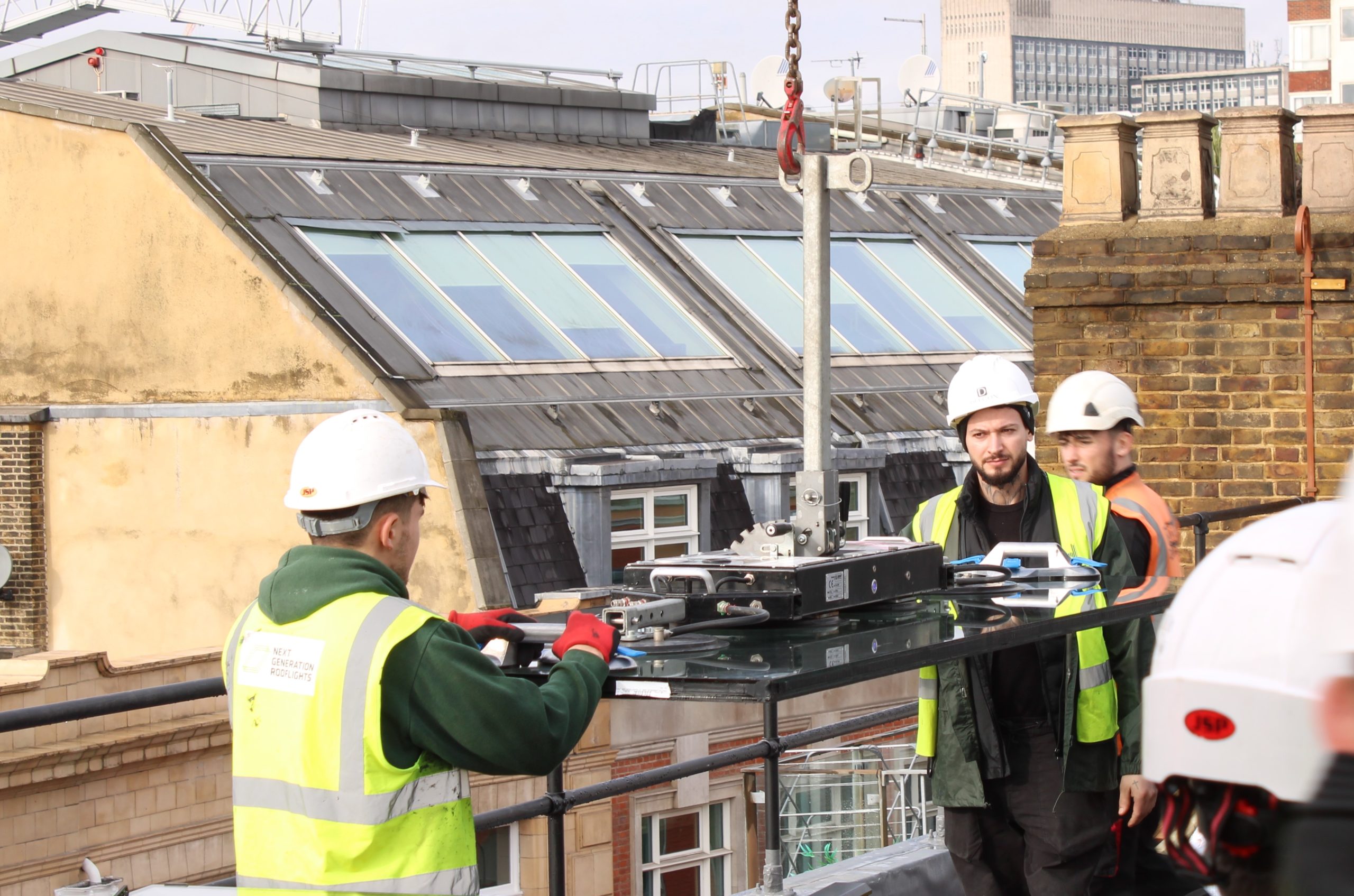 sliding-rooflight-installation-commercial-premises Installation of large-span sliding rooflight on commercial flat roof in central London providing natural daylight and ventilation.